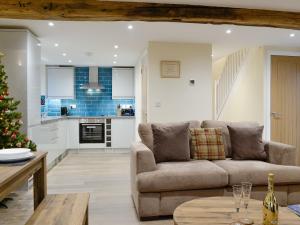 a living room with a couch and a christmas tree at Tarn Rigg Cottage - Uk1368 in Keswick