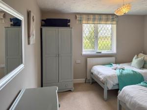 a small bedroom with two beds and a window at Archways-E1223 in Addlethorpe +19 photos