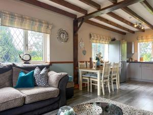 a living room with a couch and a table at Archways-E1223 in Addlethorpe