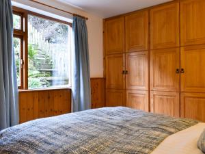 a bedroom with a bed and a window at Bell Hill Cottage in Lindale
