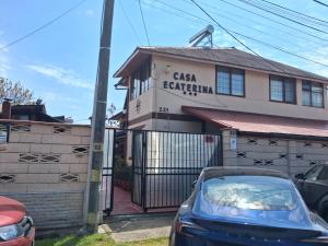 a building with a car parked in front of it at Casa Ecaterina 2Mai in 2 Mai