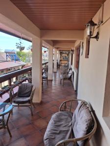 a porch with chairs and a table and a table at Casa Ecaterina 2Mai in 2 Mai