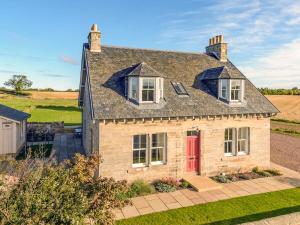 an aerial view of a brick house with a red door at Broomrigg Farmhouse in Pencaitland