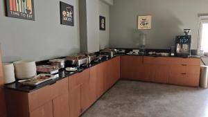a kitchen with a counter with pots and pans at Hotel Ceasta US Consulate Hyderabad, Gachibowli in Gundipet
