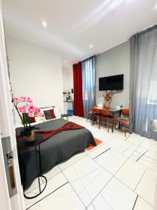 a bedroom with a bed and a dining room at Laura Rooms in La Spezia