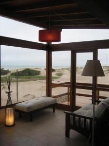 a living room with a view of the beach at Cabañas Agreste in Villa Gesell