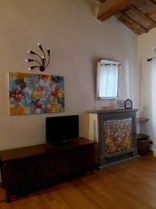 a living room with a tv and a fireplace at Berny House in Bracciano