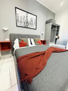a bedroom with a bed with a blanket on it at Laura Rooms in La Spezia