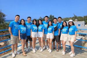 a group of people in blue t shirts posing for a picture at Moonlight House in Cu Lao Thu
