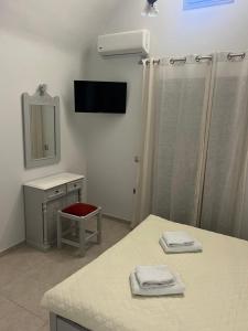 a bathroom with a sink and a shower with a mirror at Kelenis Apartments in Karterados