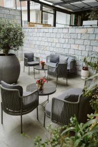 a group of chairs and tables in a patio at Destiny Hotel & SPA in Tirana