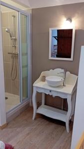 a white bathroom with a sink and a shower at La Maison des Filles in Sainte-Scolasse-sur-Sarthe +10 photos
