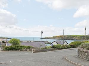 an empty street with a view of the ocean at Quayside in Cemaes Bay