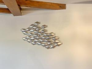 a group of silver bowls hanging on a wall at Ash Cottage E1224 in Addlethorpe