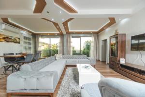 a living room with a couch and a tv at Resort Bevilacqua in Budva