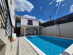 a swimming pool in the backyard of a house at Pansion & Apartments MOST Blagaj in Blagaj