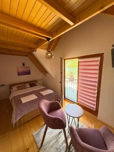 a bedroom with a bed and a table and chairs at Stara pruga Jaz 2 in Višegrad