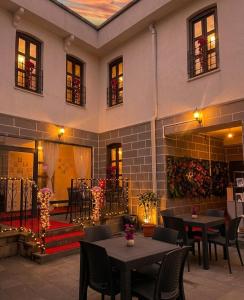 a restaurant with tables and chairs in front of a building at Grand Sur Butik Otel in Diyarbakır