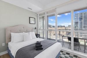 a bedroom with a bed and a large window at Toronto Harbourview Suites with free parking in Toronto +22 photos