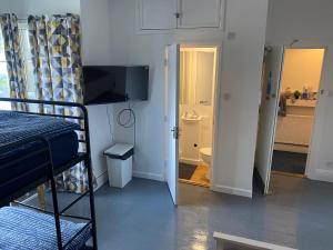 a small room with a bunk bed and a bathroom at Palace Guesthouse in Newquay +22 photos