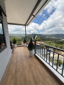 a balcony with potted plants and a view at Mây HomeStay in Da Lat