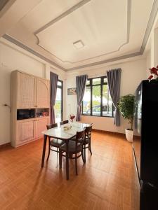 a kitchen and dining room with a table and chairs at Mây HomeStay in Da Lat