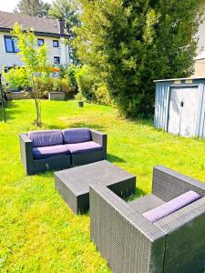 a garden with a couch and a table in the grass at Maison chaleureuse - Proche du lac in Tresserves