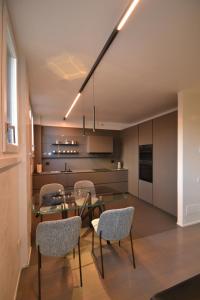 a kitchen and dining room with a glass table and chairs at Nuovo Fiore in Pesaro