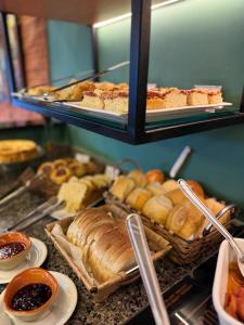 a bunch of different types of bread and pastries at Pousada Elo Inn in Recife
