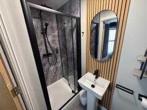 a bathroom with a shower and a sink and a mirror at Harbour View Holiday Apartment in Donaghadee +19 photos
