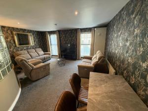 a large living room with couches and a television at Harbour View Holiday Apartment in Donaghadee