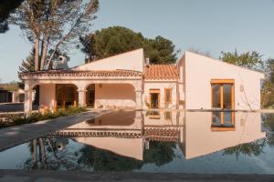 a house with its reflection in the water at Casa Valentina Ronda in Ronda