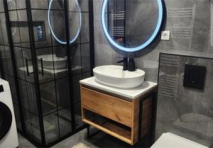 a bathroom with a sink and a mirror at Nora in Žepče +9 photos
