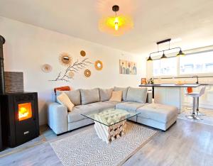 a living room with a couch and a fireplace at Maison chaleureuse - Proche du lac in Tresserves