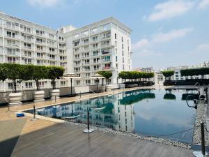 a large building with a pool in front of a building at Golden Pent House in Lucknow