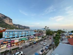 a busy street in a city with cars and buildings at J Mansion in Ao Nang Beach +58 photos
