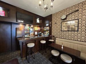 a bar in a restaurant with stools at a counter at The Westbourne Guest House in Llandudno