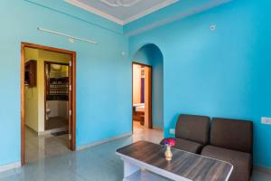 a living room with a couch and blue walls at Indu BNB Shimla in Shimla