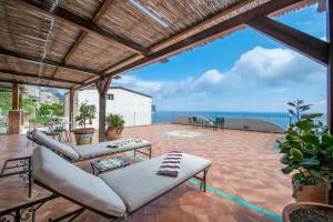 an outdoor patio with a view of the ocean at Il Giardino Dei Limoni in Praiano