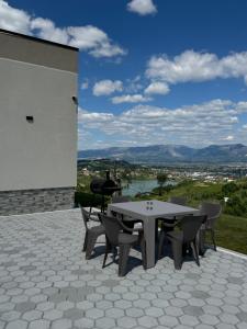 a table and chairs on a patio with a view at The Lake Villa in Tirana