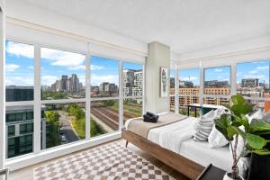 a bedroom with a bed and large windows at Toronto Harbourview Suites with free parking in Toronto