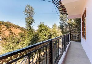a balcony with a view of a mountain at Indu BNB Shimla in Shimla