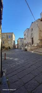 an empty street with buildings and a red fire hydrant at Kylix Home in Campobasso