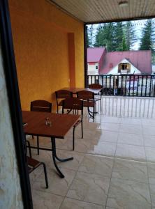a room with tables and chairs and a large window at Hotel Pagio in Chaisubani