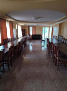 a room with tables and chairs and a couch at Hotel Pagio in Chaisubani