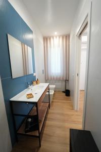 a bathroom with a sink and a toilet and a mirror at Maison d'Elite in Marigliano