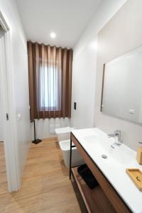 a bathroom with a sink and a toilet and a mirror at Maison d'Elite in Marigliano +17 photos
