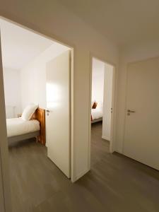 an empty room with a bed and a mirror at DOMITYS LA CALYPSO in Brest