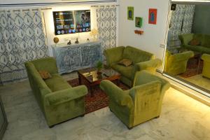 a living room with two chairs and a fireplace at C44thelocalhistory in Jaipur