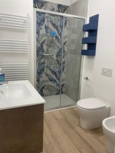 a bathroom with a shower and a toilet and a sink at pinetadamare in Porto SantʼElpidio +14 photos